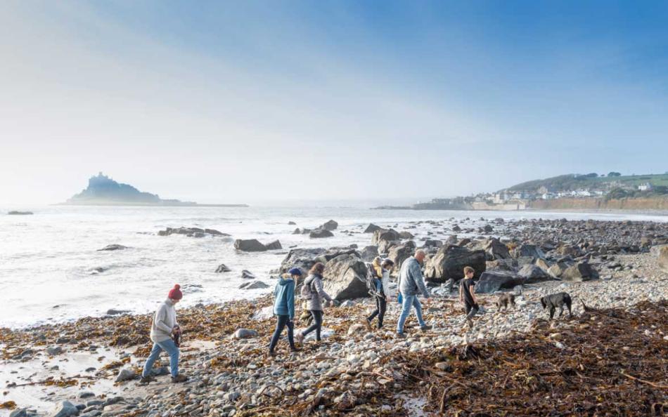 A Group of Walkers Enjoing the Cornish Coastline near St Michaels Mont on a Cold Winters Day 