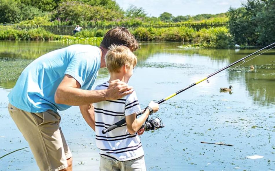 A Father Teaching his Son to Fish at a Lakeside