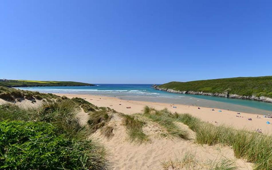 People Dotted along the Shoreline at Crantock Beach in Cornwall