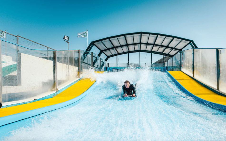 A Person Body Boarding on a Surf Simulator on a Holiday Park Near Woolacombe