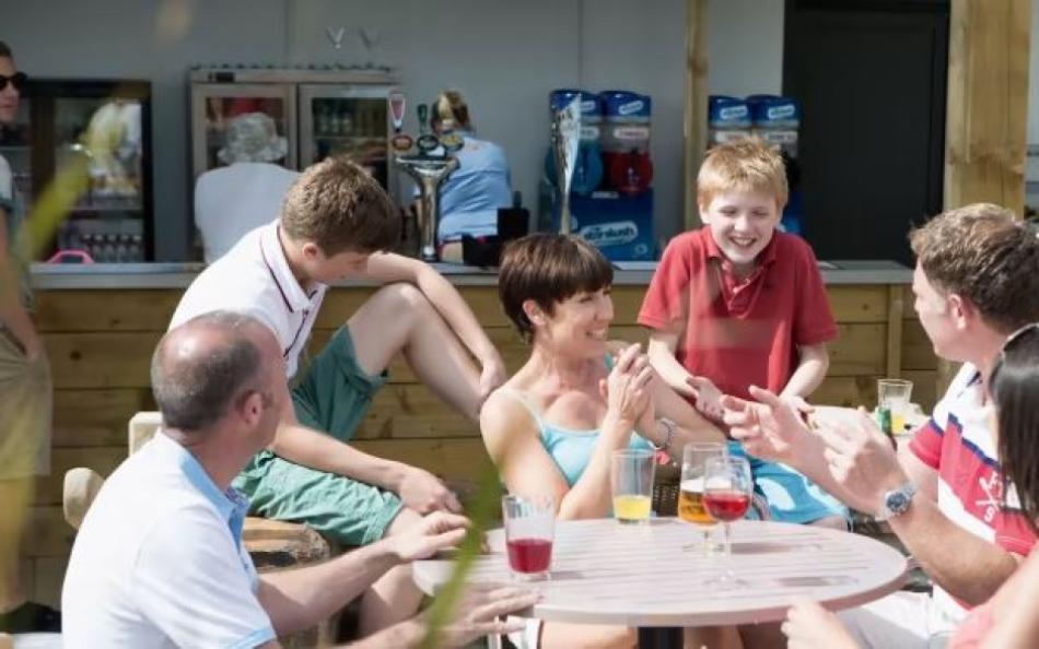 Families Enjoying a Lunch Time Drink on the Holiday Park Pub in Cornwall