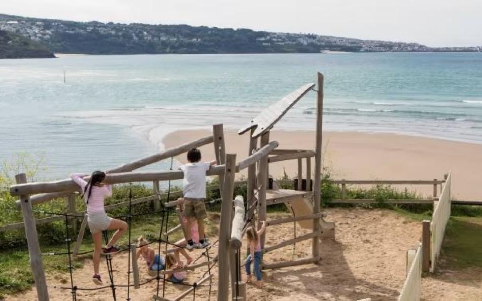 A Family in a Childrens Play Area on a Holiday Park in Cornwall