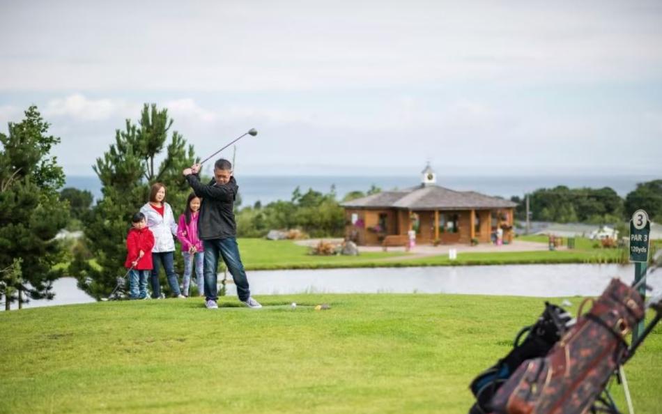 A Family Enjoying a Game of Golf on a top 8 Scotland holiday park