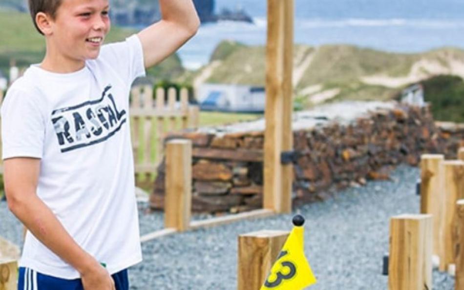 A Child Playing Crazy Golf Overlooking the Sea