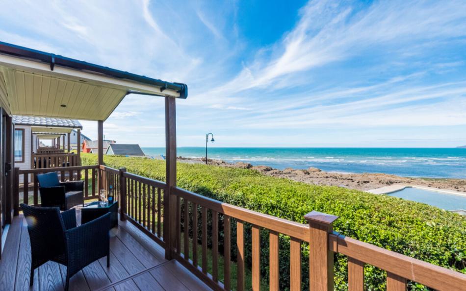 A Caravan Holiday Home Decking Area Overlooking the Sea Pool and Sea at Westward Ho!