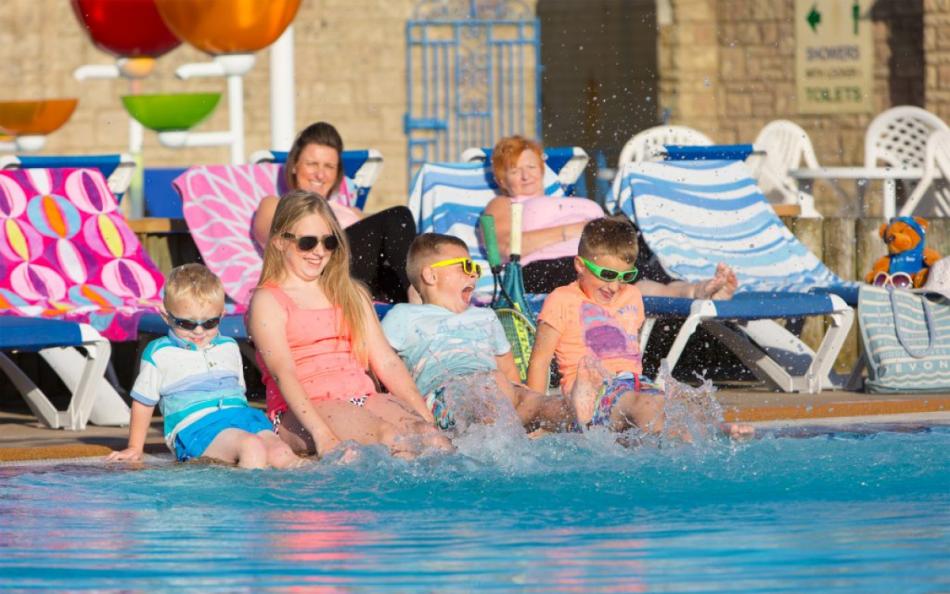 A Family Splashing in the Swimming Pool at holiday parks in Torquay