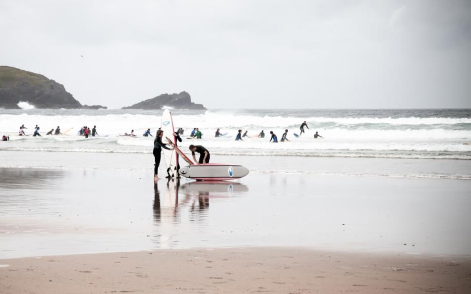 People in the Surf and Preparing to Surf on a Beach Near Newquay Cornwall