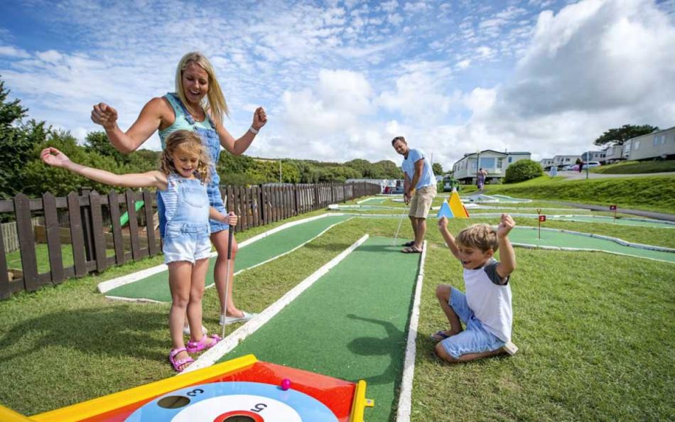 A Family Playing a Game of Crazy Golf on a Cornish Holiday Park