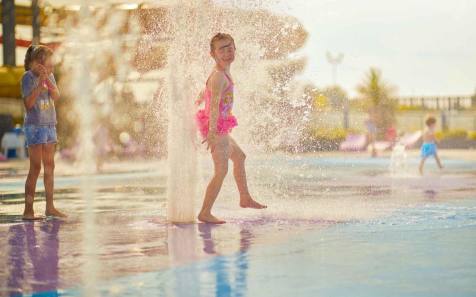 Children Playing in Water Spray Area on a Holiday Park in Skegness
