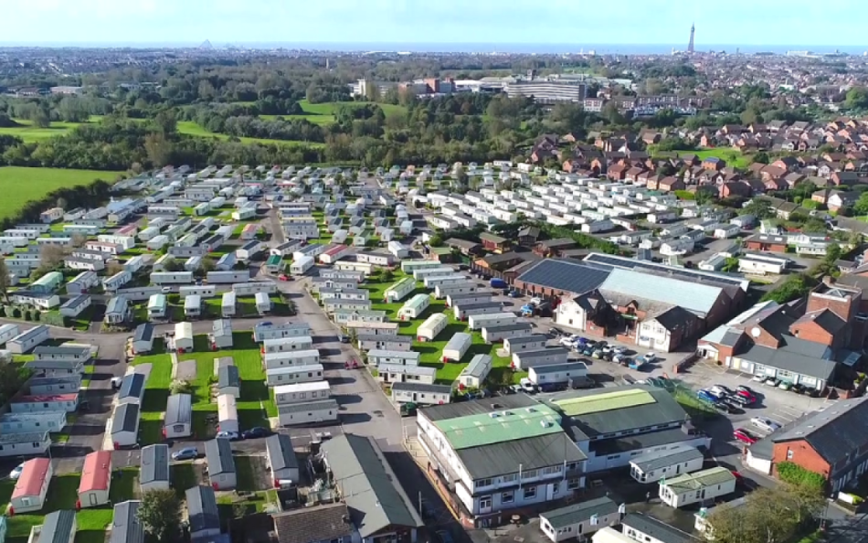 An Arial View of the Holiday Park Surrounded by Trees and the Blackpool Tower in the far Distance