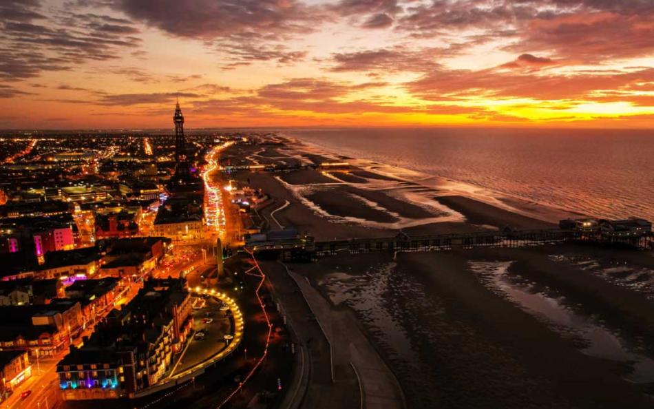 A View of Blackpool at Sunset with Street Lights Matching the Colour of the Sunset