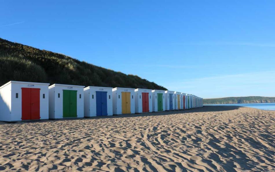 A Row of Colourful Beach Huts on Woolacombe Beach in North Devon