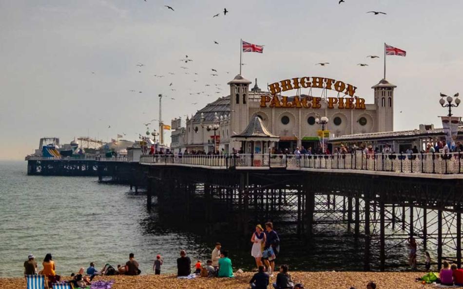 Brighton Palace Pier with People on a Shingle Beach