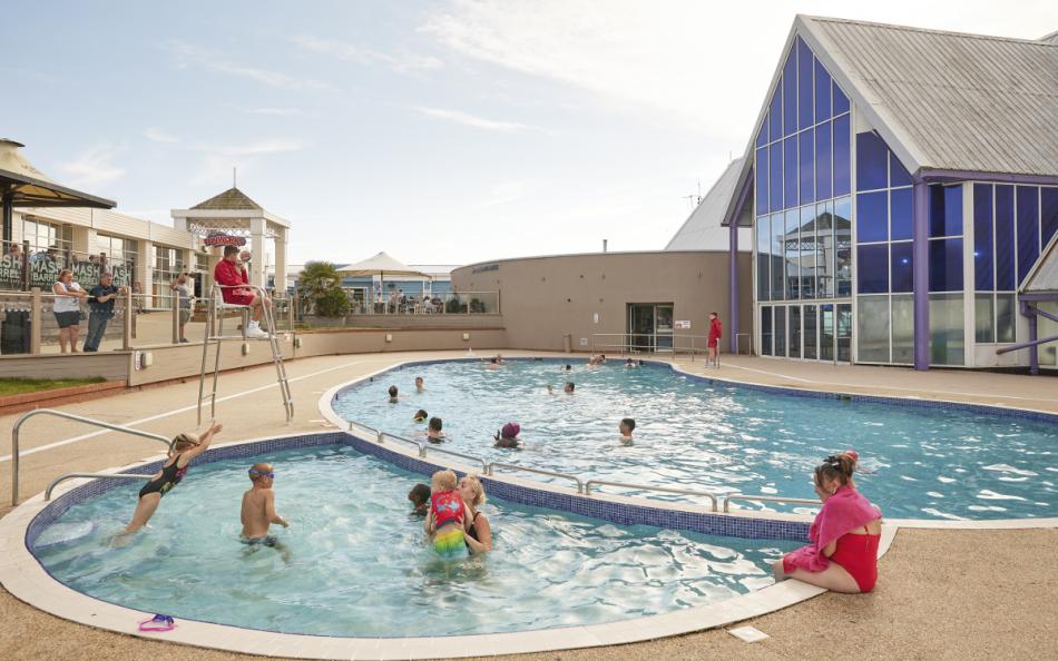 People Enjoying Time in the Outdoor Pool at the Holiday Park