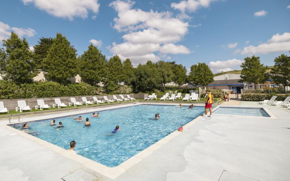 People Swimming in an Outdoor Pool at Seaview holiday park in Weymouth