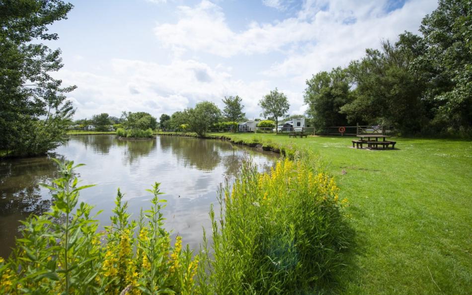 A Fishing Lake Near some Caravans