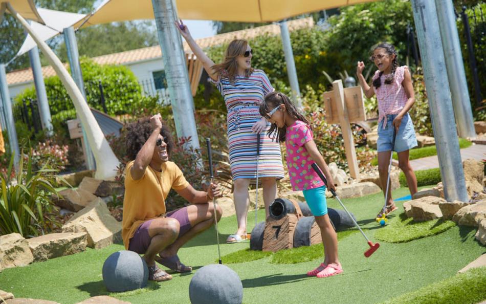 Family enjoying a game of Crazy Golf on a Holiday Park