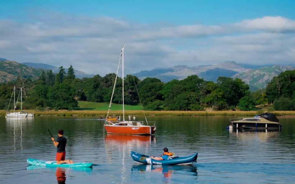 People enjoying being on a lake on a variety of water craft