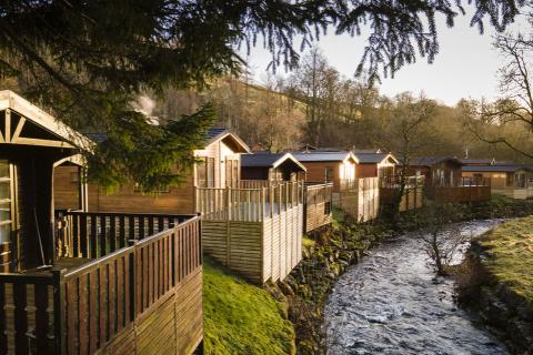 lodges by the river in the lake district at Limefitt Holiday Park