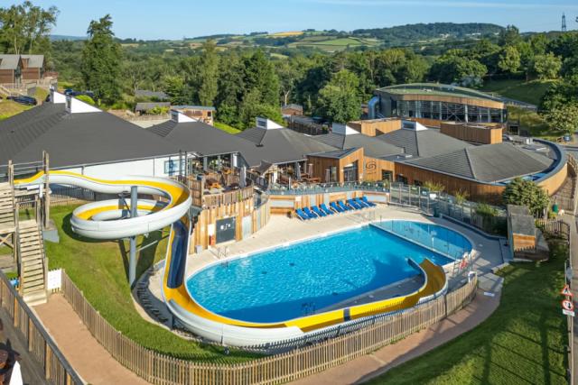 the outdoor swimming pool with slides at Finlake Resort & Spa holiday park in Devon