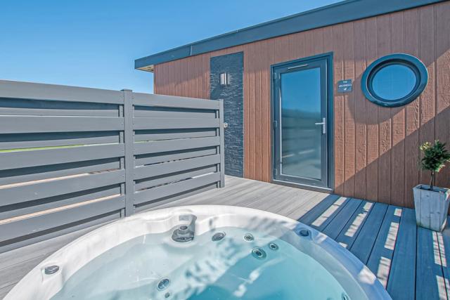 lodge with a tot tub at maesmawr farm resort in powys