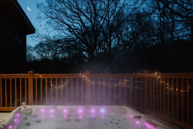 hot tub lodges at night at Rockingham Forest Holiday Park in northamptonshire