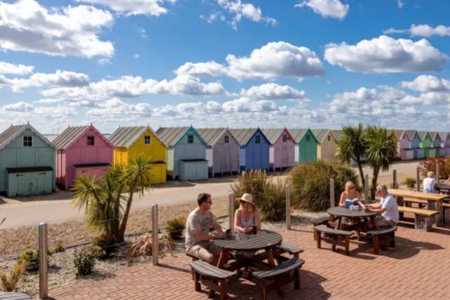 outside bar area with beach huts at West Mersea Holiday Park