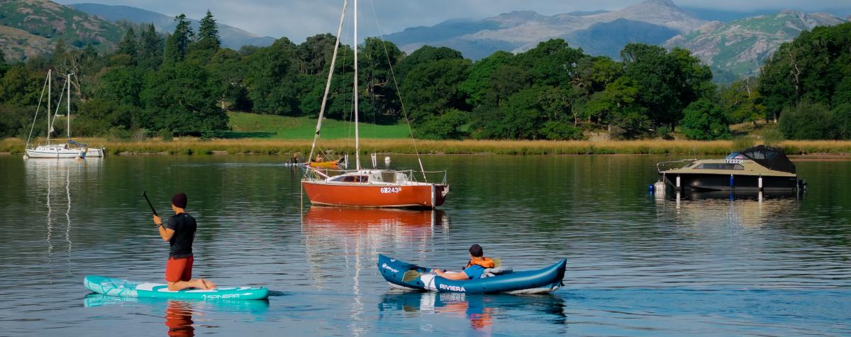 People enjoying being on a lake on a variety of water craft