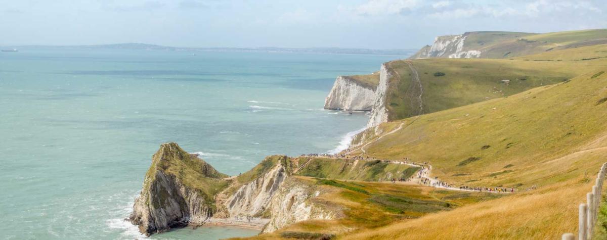 A Person Walking Along a Dorset Coastline
