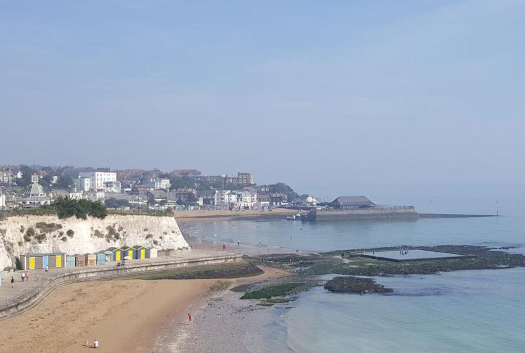 A View of a Coastal Village with a Sea Pool on a Sunny Day