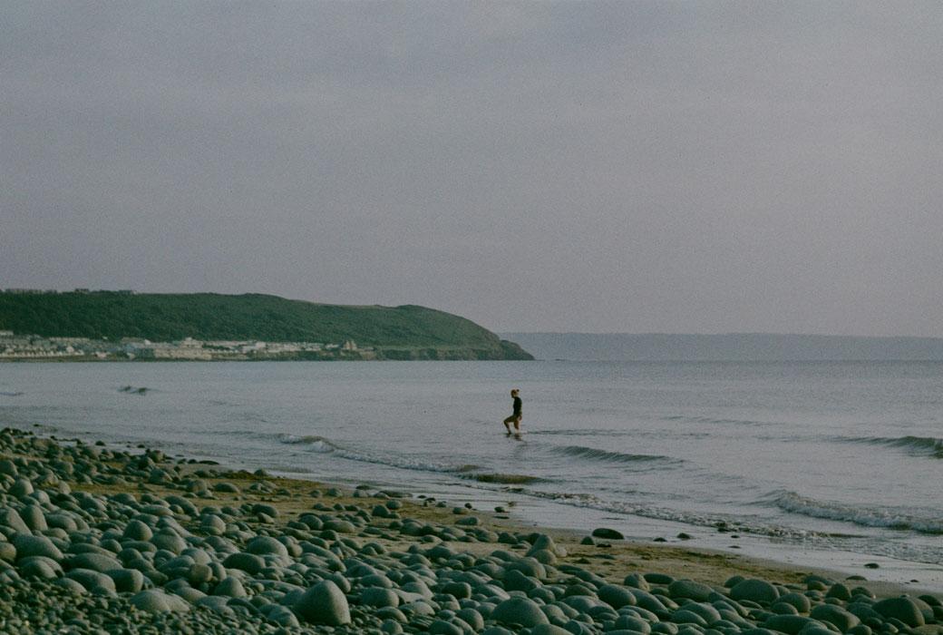 One person walking through the Sea at Westward Ho!