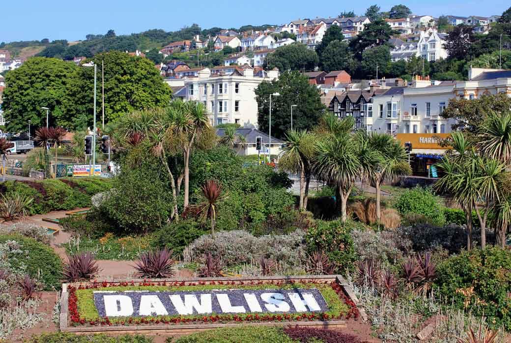Devon town sign surrounded by flowers and trees