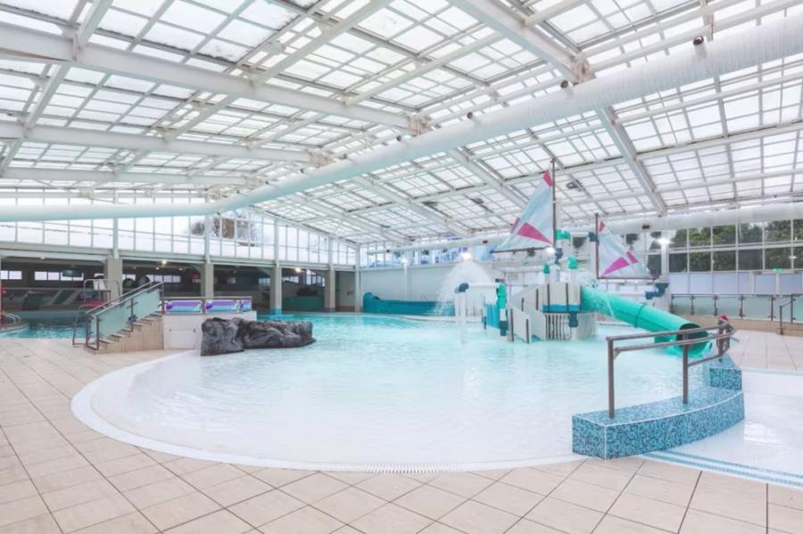 indoor swimming pool with flume at Devon Cliffs Holiday Park
