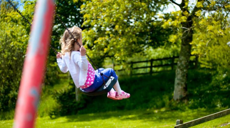 on the swings on holiday