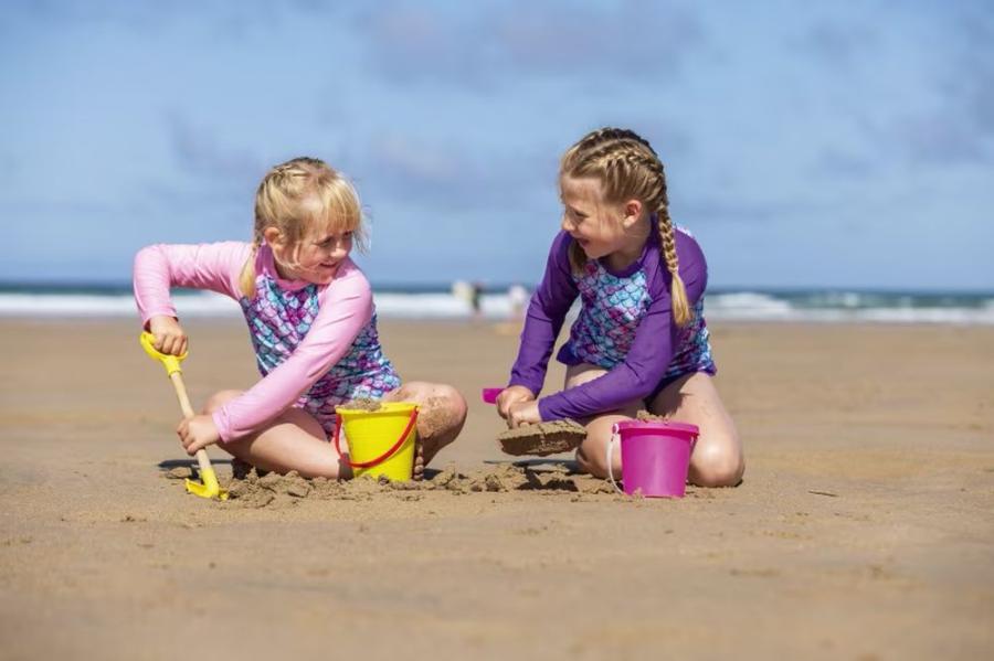 digging in the sand on Prranporth beach