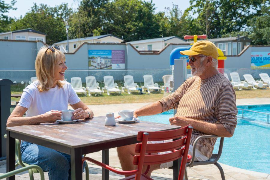 relaxing by the pool at Golden Sands Holiday Park