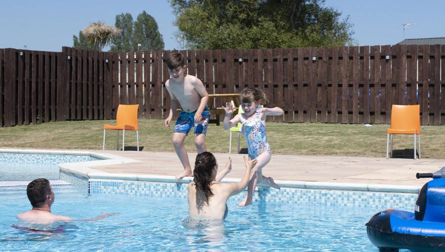 messing about in the outdoor pool at Coopers Beach Holiday Park