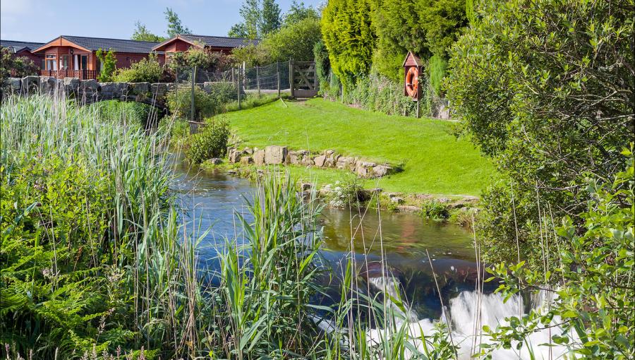holiday lodges by a stream in cornwall
