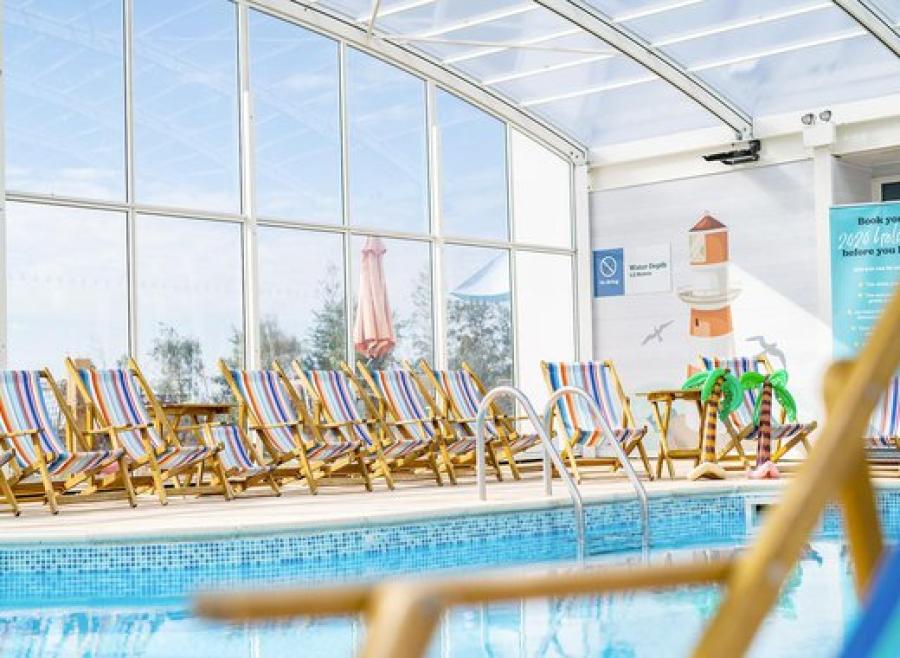 swimming pool with deck chairs