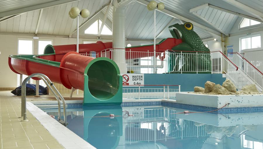 the indoor swimming pool with slides at Thorness Bay Holiday Park