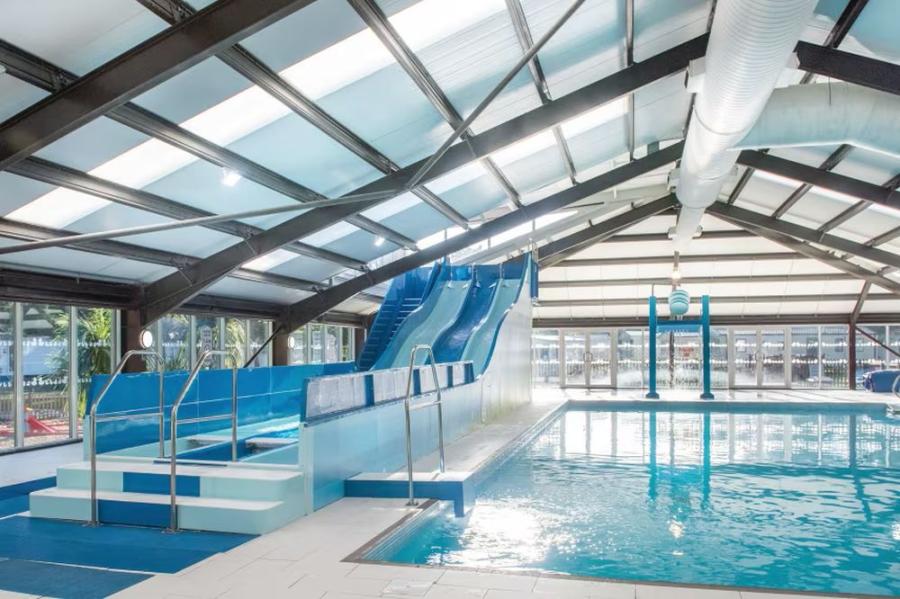 the indoor swimming pool with slides at Wild Duck Holiday Park