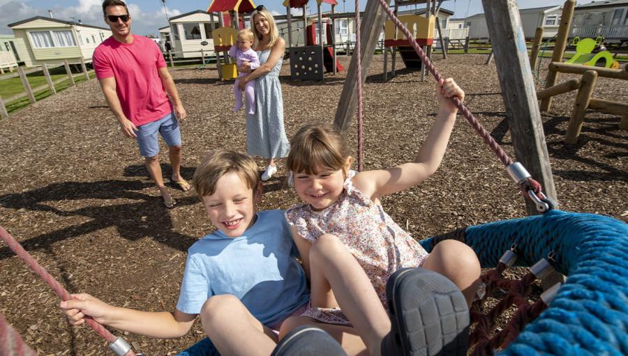 on the swings on holiday at Barmston Beach Holiday Park