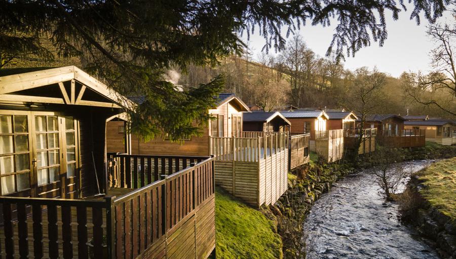 lodges by the river in the lake district at Limefitt Holiday Park