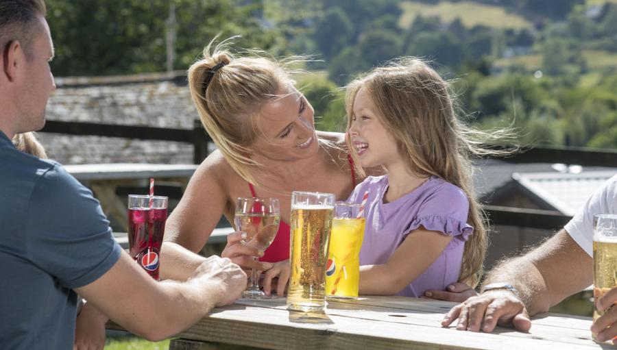 having a drink outside at Limefitt Holiday Park
