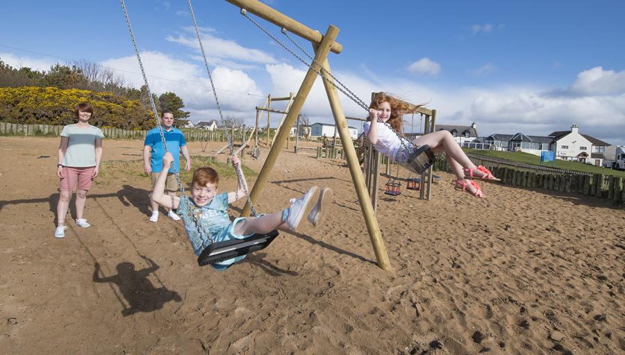 on the swings at Grannie's Heilan Hame Park