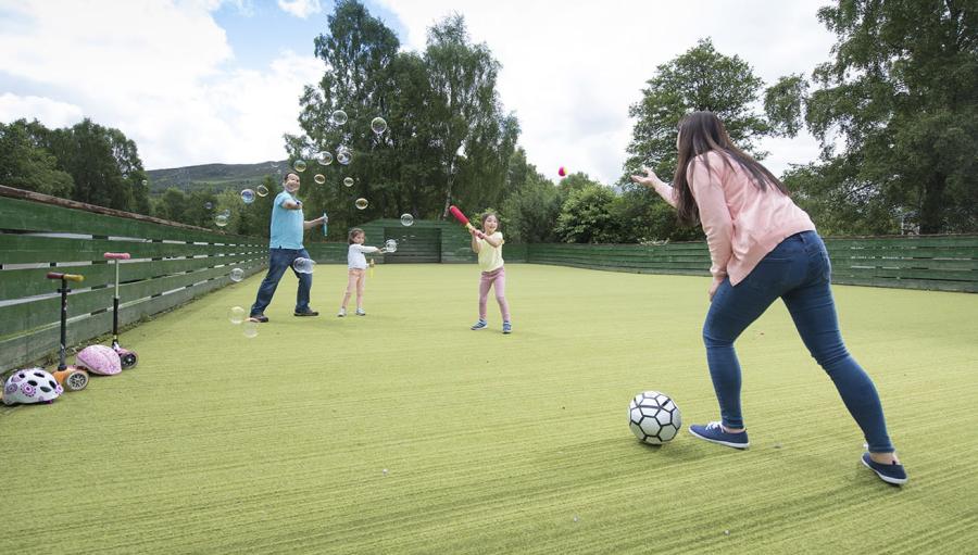 playing football in the multi sports court at Tummel Valley Holiday Park