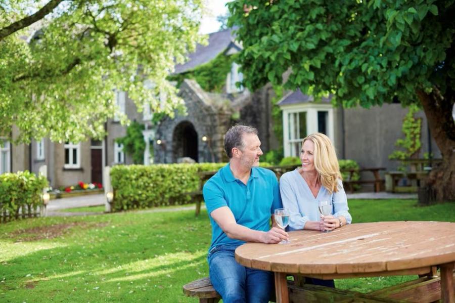 sitting outside the manor house at Lydstep Beach Holiday Park