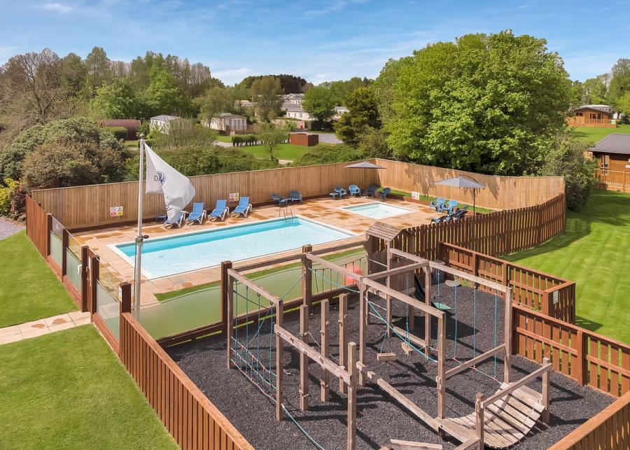 the outdoor pool and playground at Dartmoor View Holiday Park