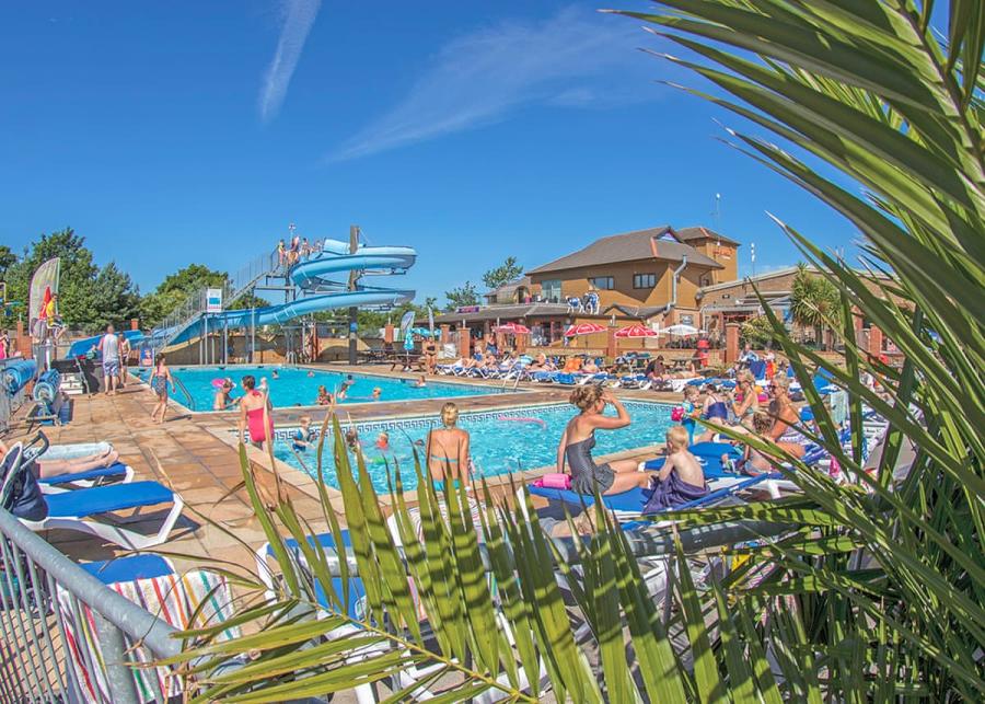 enjoying the sun by the outdoor pool at Lady’s Mile Holiday Park