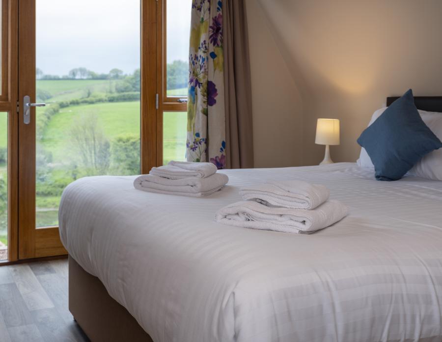 double bed in a pod with views of Exmoor